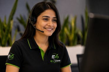 Smiling customer support agent wearing a headset and branded shirt.