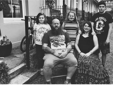 Isabeau (standing centre) with her family outsider her home (same Maidstone house) 2021