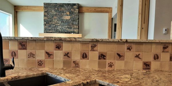 western ceramic tiles featuring animal tracks, wildlife and gamebirds added to a kitchen backsplash