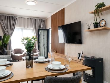 Modern living and dining room with cozy furniture and decor.