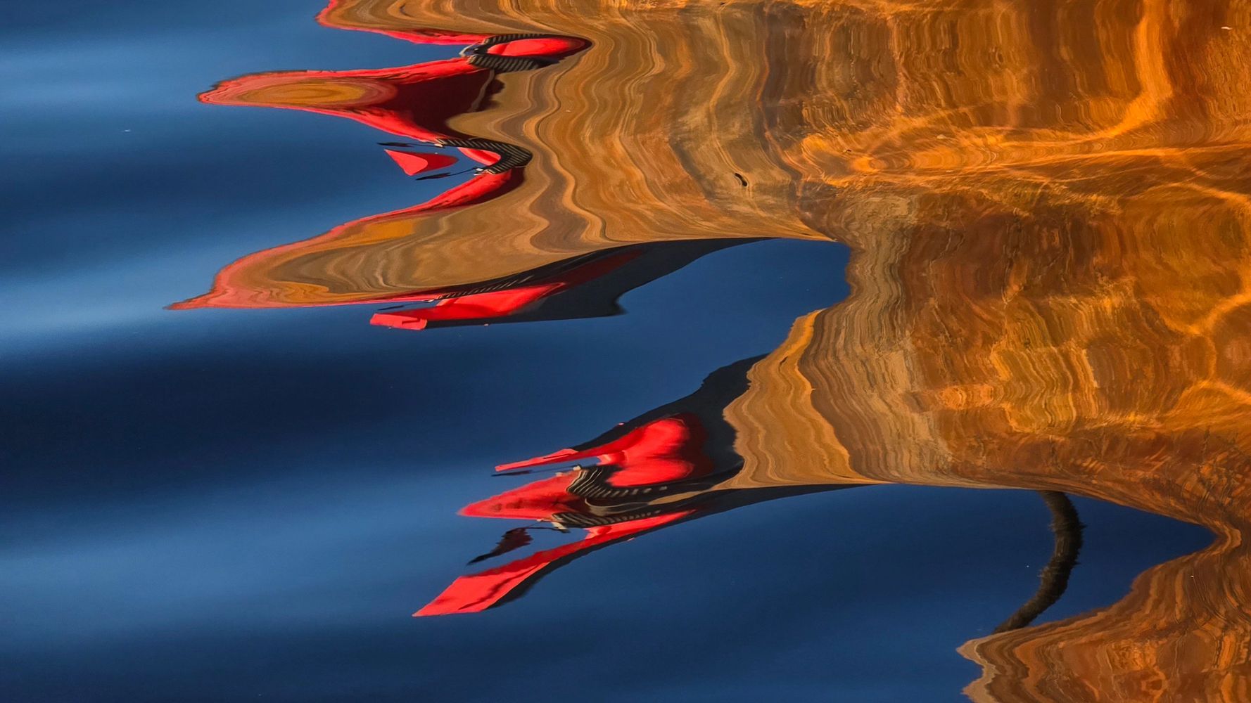 Three adults focused on drawing portraits on easels in an art class.
