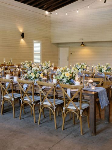 pale yellow, light blue, sage green and white floral reception farm table centerpieces