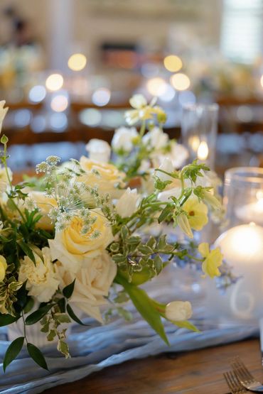 pale yellow, light blue, sage green and white floral reception centerpieces