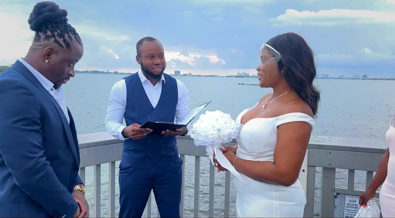 Professional wedding officiant conducting a joyful outdoor ceremony for a couple in South Florida.