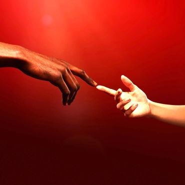 Two hands with different skin tones reaching out to touch fingers against a red background.