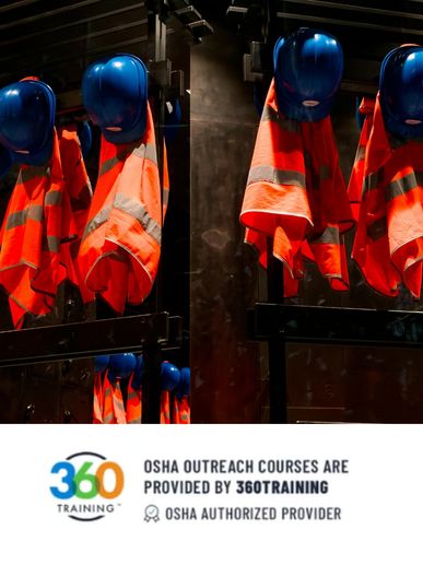 Orange safety vests and blue helmets hanging in a workplace setting.