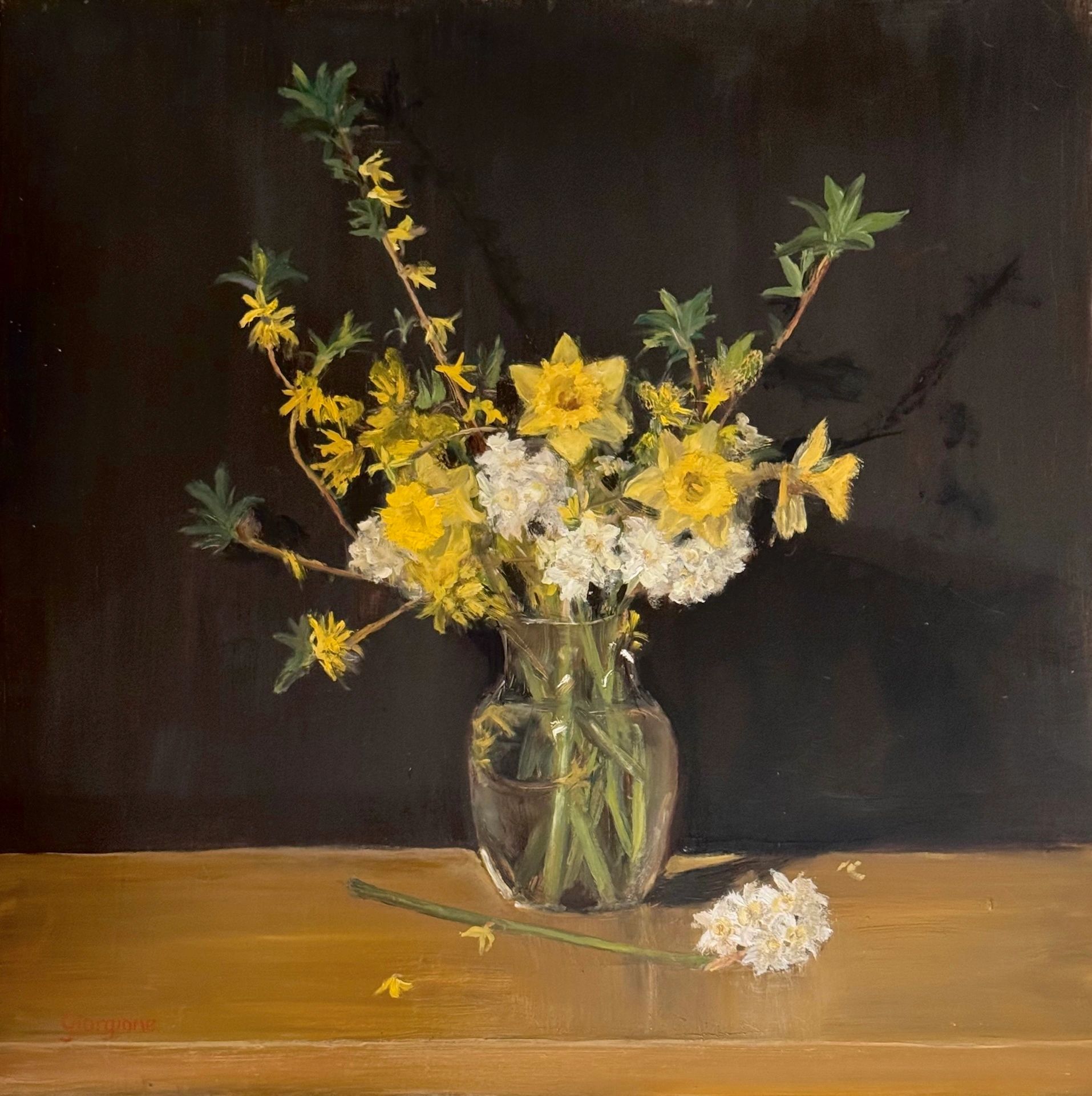 Spring bouquet yellow flowers, daffodils, forsythia, paper whites, glass vase, black background
