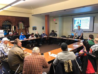 A meeting held in the conference room of the historic Borden's Hotel