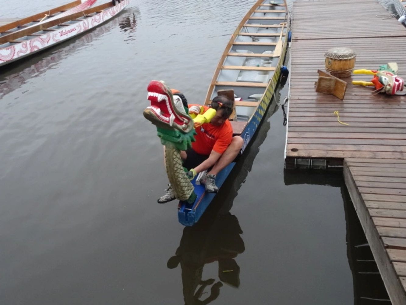 Dragon boat figurehead being attached to boat. 2017, Madisonville, LA (photo: C.Olsen)
