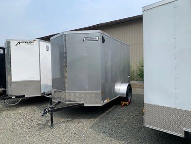 Haulmark 6x10' Passport Deluxe silver enclosed utility trailer with rear ramp.