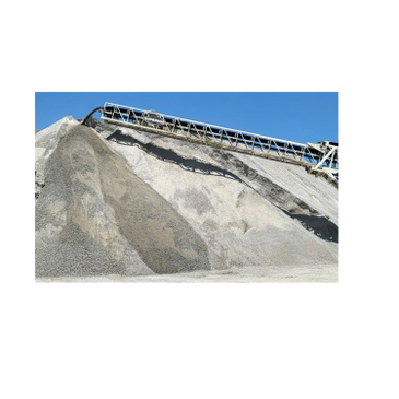 Large piles of gravel with a conveyor belt under a clear blue sky.