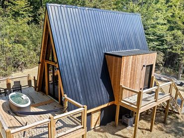 a frame cabin black metal roof