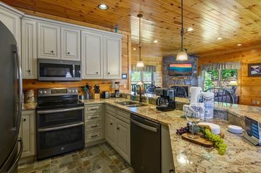Cabin Kitchen with pine walls and granite countertops in Gatlinburg Falls Resort