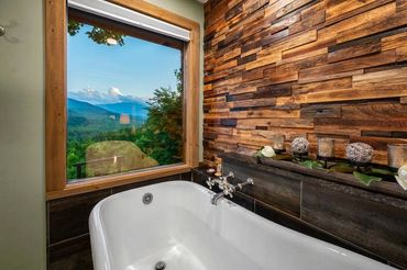 Custom wood wall above bathtub by Adler Peak Enterprises Construction