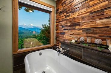 Custom wood wall above bathtub by Adler Peak Enterprises Construction