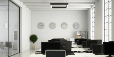 Picture of a office with desk, black chairs and computer monitor.