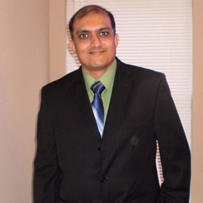 Upen Pandya Print services staff team member at 1 stop print tx smiling man in suit