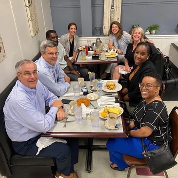 small group of banking, CDFI, economic-development, and business leaders around a conference table.