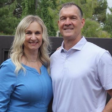 Smiling couple posing outdoors.