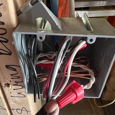 Close-up of electrical wiring inside a junction box with wire nuts.