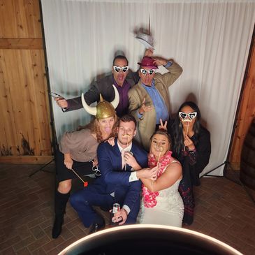 People in photo booth with silly props at a wedding at Bending Branch Ranch in New Smyrna Beach Flor