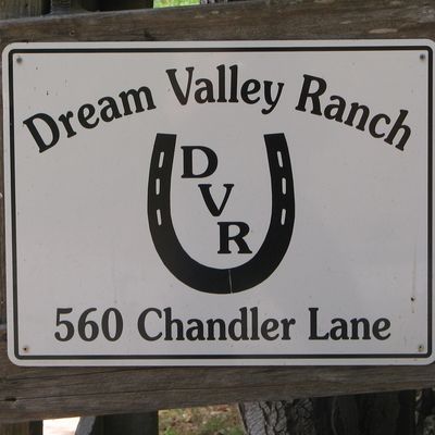 a sign with the words "Dream Valley Ranch 560 Chandler Lane" and a horse shoe