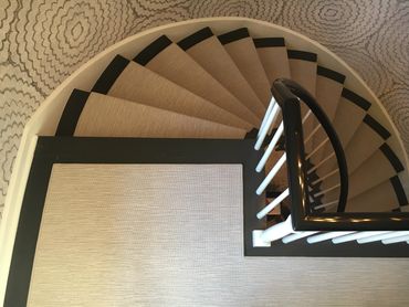Century old curved stairs, with stair-runner and matching rug.