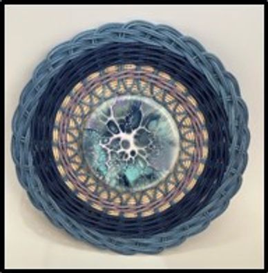 Intricate circular woven basket with blue and black hues.