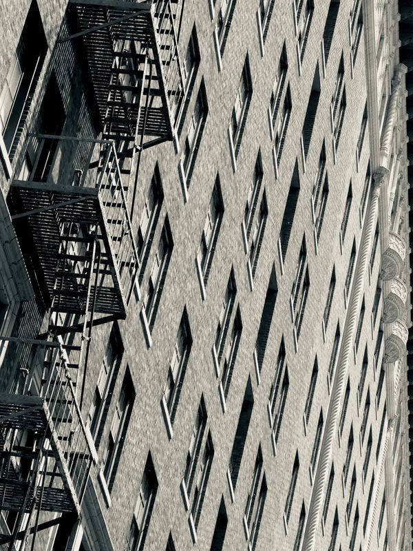 Urban building facade with fire escape stairs.