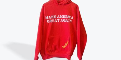 Red Make America Great Again Hoodie with the signature of your favorite President Donald Trump