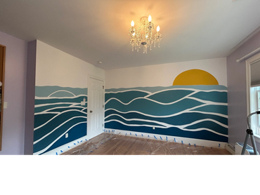 Sun and ocean mural in children's bedroom