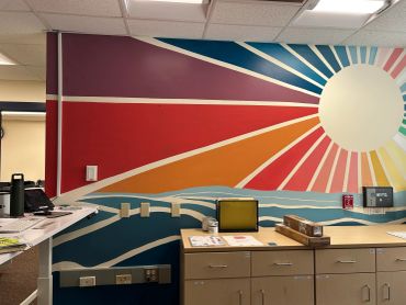Rainbow sun mural at elementary school in Maine