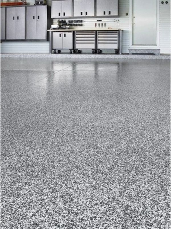 Clean epoxy-coated garage floor with cabinets.