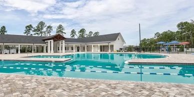 Commercial property with a blue pool. Pool safety rings floating in the water.
