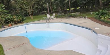 Renovating a pool, reviving and bringing older pool back to life. Water is half removed.