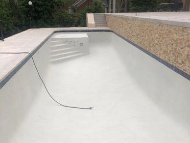 freshly poured pool or empty hot tub to renovate new landscaping around pools.