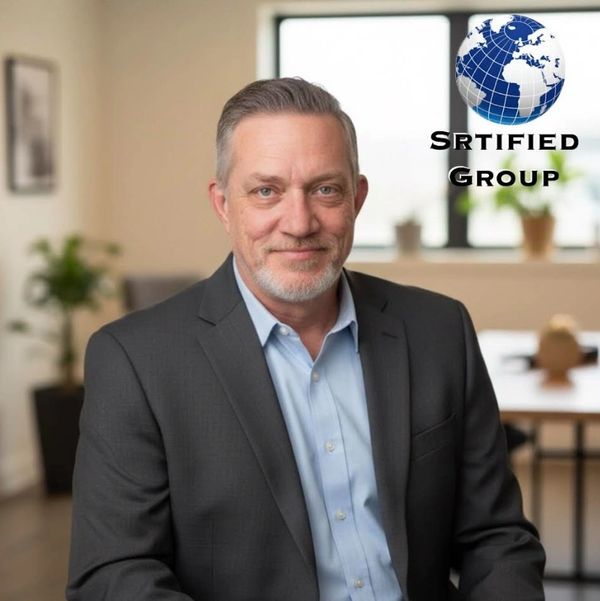 Professional man in suit smiling in an office setting with a globe logo.