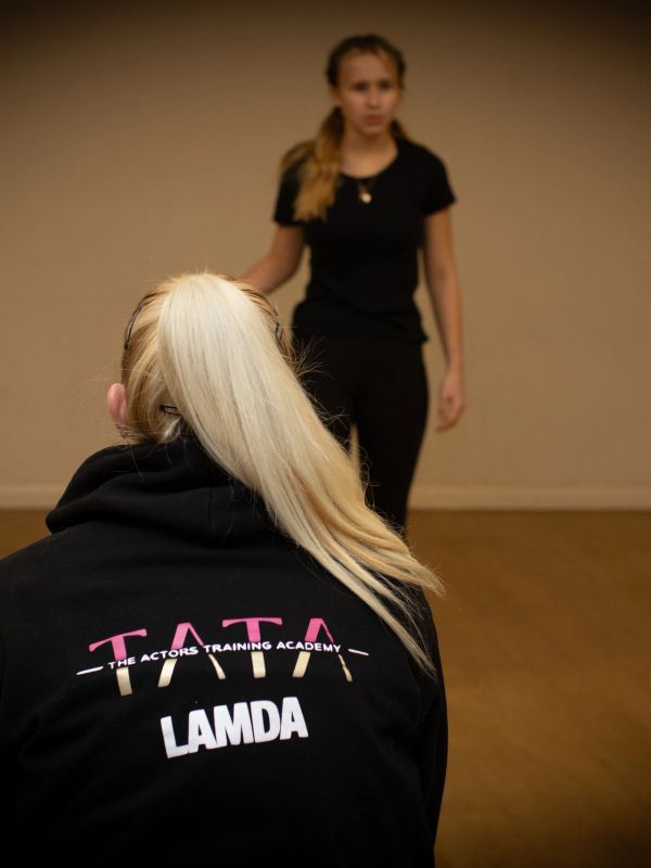 Two women in a training room, one wearing a Tata LAMDA hoodie.