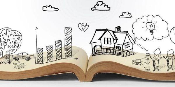 Open book with creative doodles of graphs, house, and ideas.