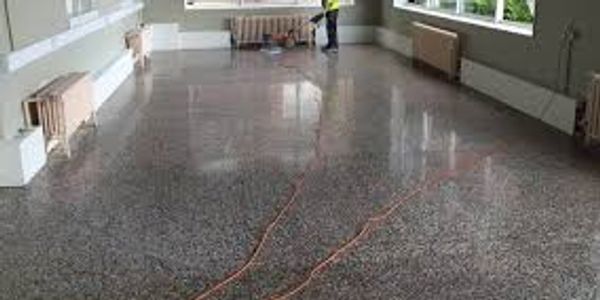 Worker finishing a polished concrete interior