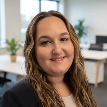 Professional woman smiling in a modern office setting.