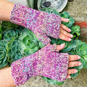 hand knit fingerless gloves that are purple with white specks