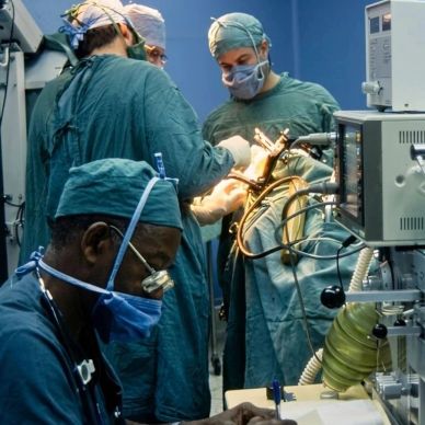 Surgeons performing an operation in a hospital operating room.