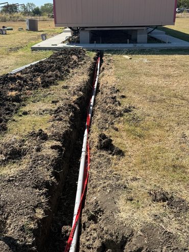 Excavation trenching for electrical connection to home and outside service meter.