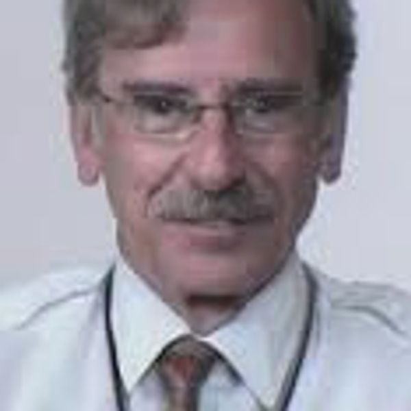Middle-aged man with glasses and mustache.