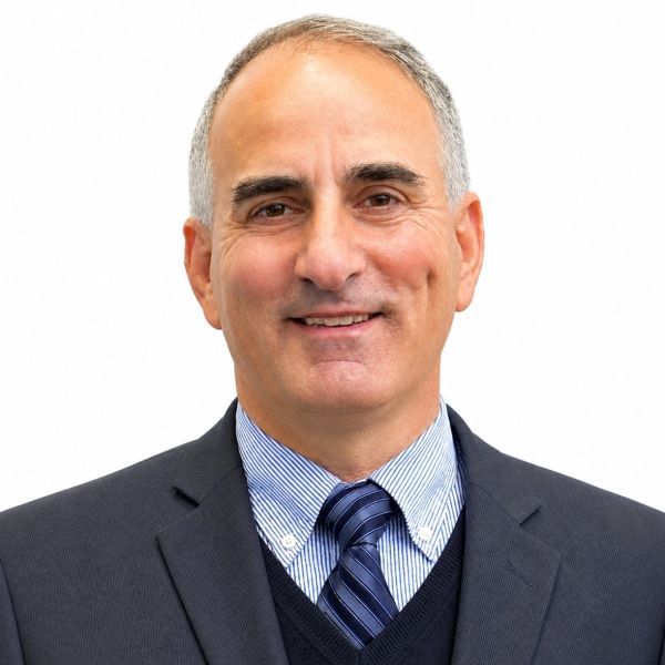 Smiling middle-aged man in suit and tie.