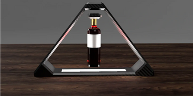 A wine bottle suspended within a triangular frame on a wooden surface.