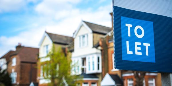 To let sign with houses on the background