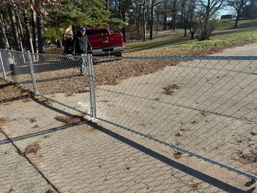 4 foot steel galvanized, chain-link fence installation with a custom angled gate