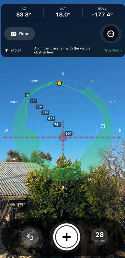 Screen showing compass and camera alignment against a clear sky and foliage.